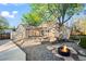 Spacious backyard with a wooden deck, fire pit, and mature trees offering shade at 12665 Grove Ct, Broomfield, CO 80020