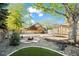 Landscaped backyard featuring a cozy fire pit area, patio, and mature trees at 12665 Grove Ct, Broomfield, CO 80020