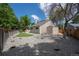 A large backyard with wooden fence, lawn and rock garden at 12665 Grove Ct, Broomfield, CO 80020