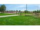 A fenced baseball field features a well-groomed green lawn, tall light pole, and backstop for game play at 12665 Grove Ct, Broomfield, CO 80020