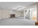 Spacious basement featuring a cozy fireplace and staircase leading to the upper level at 12665 Grove Ct, Broomfield, CO 80020