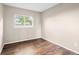 Neutral bedroom featuring hardwood floors and a bright window at 12665 Grove Ct, Broomfield, CO 80020