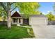 Charming one-story home featuring a well-maintained lawn, attached garage and inviting walkway at 12665 Grove Ct, Broomfield, CO 80020