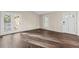 Bright living space boasts durable dark wood laminate floors and patio door to private yard at 12665 Grove Ct, Broomfield, CO 80020