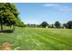 Expansive green park with lush grass and a colorful playground, offering endless opportunities for recreation and community enjoyment at 12665 Grove Ct, Broomfield, CO 80020