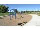 This vibrant playground, with blue climbing structures and swings, is surrounded by green space for active outdoor fun at 12665 Grove Ct, Broomfield, CO 80020