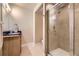 This bathroom features a tile shower with a glass door, a vanity, and a neutral color palette at 6727 W Yale Ave, Lakewood, CO 80227