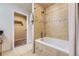 Bathroom with tiled bathtub, shower, tiled floors, and access to a closet at 6727 W Yale Ave, Lakewood, CO 80227