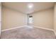 An empty bedroom area featuring neutral carpet, a window, and white base trim at 6727 W Yale Ave, Lakewood, CO 80227