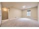 Spacious carpeted bedroom with a large window and neutral walls at 6727 W Yale Ave, Lakewood, CO 80227