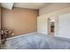 Neutral-toned bedroom with plush carpet, access to bathroom, and space for personalization at 6727 W Yale Ave, Lakewood, CO 80227