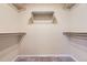 Walk-in closet with neutral walls, carpeted floors, and metal racks for organizing clothes at 6727 W Yale Ave, Lakewood, CO 80227