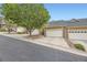Street view of tan townhomes with two-car garages at 6727 W Yale Ave, Lakewood, CO 80227