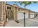 Home exterior showcasing a 2-car garage and stone detailing at 6727 W Yale Ave, Lakewood, CO 80227