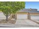 Charming townhome featuring a two-car garage and stone accents at 6727 W Yale Ave, Lakewood, CO 80227