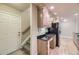 Bright kitchen with black appliances, wood cabinets, granite counters, and wood floors at 6727 W Yale Ave, Lakewood, CO 80227