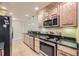 Kitchen featuring stainless steel appliances and wooden cabinetry at 6727 W Yale Ave, Lakewood, CO 80227