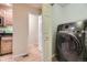 Modern laundry area with updated appliances, including a front load washer dryer at 6727 W Yale Ave, Lakewood, CO 80227