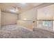 Well-lit loft space offering versatile options, carpet floors, and a ceiling fan at 6727 W Yale Ave, Lakewood, CO 80227