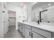 Modern bathroom featuring double sinks, sleek vanity, and a walk-in shower at 5688 N Killarney Ct, Aurora, CO 80019