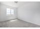 Light-filled carpeted bedroom with a large window showing bright sky and distant landscape at 5688 N Killarney Ct, Aurora, CO 80019