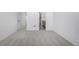 Bedroom with neutral carpet, white walls, and ensuite bathroom at 5688 N Killarney Ct, Aurora, CO 80019