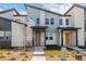 A modern townhome exterior with a stone facade and a pop of color from the cheerful yellow front door at 5688 N Killarney Ct, Aurora, CO 80019