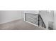 Upper hallway landing with modern black railing, plush carpet, and views of the outdoors through transom windows at 5688 N Killarney Ct, Aurora, CO 80019