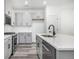 Stylish kitchen with gray cabinets, stainless steel appliances, white subway tile backsplash, and quartz countertops at 5688 N Killarney Ct, Aurora, CO 80019