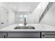 Modern kitchen island with sink, gray cabinetry, stainless steel appliances and light countertops at 5688 N Killarney Ct, Aurora, CO 80019