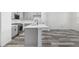 Modern kitchen with gray cabinets, stainless steel appliances, and a large center island with white countertop at 5688 N Killarney Ct, Aurora, CO 80019