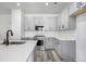 Bright kitchen with gray cabinets, stainless steel appliances, and white quartz countertops, and modern sink and faucet at 5688 N Killarney Ct, Aurora, CO 80019