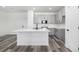 Modern kitchen with gray cabinets, white countertops, a center island with sink, and stainless steel appliances at 5688 N Killarney Ct, Aurora, CO 80019