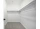 A walk-in closet featuring carpeted floors, shelving, and a clothing bar at 5688 N Killarney Ct, Aurora, CO 80019