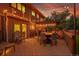 Outdoor living space with pergola, string lights, dining set and a landscaped lawn provides the perfect relaxation area at 7678 Newman St, Arvada, CO 80005