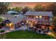 Dusk aerial showcasing the backyard, deck, pergola, gardens, and exterior lighting, offering a great entertaining space at 7678 Newman St, Arvada, CO 80005
