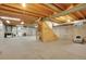 Unfinished basement with exposed beams, concrete walls, laundry appliances, and potential for customization at 7678 Newman St, Arvada, CO 80005