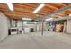 Unfinished basement featuring a laundry area with washer and dryer hookups and space for storage and utilities at 7678 Newman St, Arvada, CO 80005