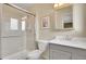 Bright bathroom showcasing a glass door shower, a toilet, and a modern vanity with a framed mirror at 7678 Newman St, Arvada, CO 80005