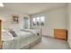 Cozy bedroom featuring a soft queen bed, a window for natural light, and a wooden dresser for ample storage space at 7678 Newman St, Arvada, CO 80005
