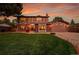 Charming home with a well-manicured lawn, a brick and siding facade, and a cozy front porch at 7678 Newman St, Arvada, CO 80005