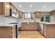 A well-lit kitchen with wooden cabinets, stainless steel appliances, and subway tile backsplash at 7678 Newman St, Arvada, CO 80005