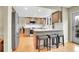 An open kitchen with a central island, stainless steel appliances, and hardwood floors at 7678 Newman St, Arvada, CO 80005