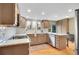 Updated kitchen featuring stainless steel appliances, white subway tile, and light wood cabinets at 7678 Newman St, Arvada, CO 80005