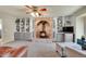 Cozy living room featuring a brick fireplace with wood-burning stove and built-in shelving at 7678 Newman St, Arvada, CO 80005