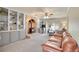 Comfortable living room with a brick fireplace, built-in shelves, and large window at 7678 Newman St, Arvada, CO 80005