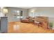 Bright living area showcasing hardwood floors, a large window, and a comfortable sitting area at 7678 Newman St, Arvada, CO 80005