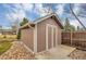 Exterior shot of a backyard storage shed featuring siding and concrete platform with rock surround at 7678 Newman St, Arvada, CO 80005