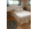 Serene bedroom with hardwood floors, a comfortable bed, and side tables at 14751 E 24Th Ave, Aurora, CO 80011