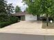 Charming single-story home with a spacious driveway and a well-maintained front yard at 14751 E 24Th Ave, Aurora, CO 80011
